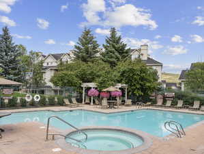 View of pool featuring a hot tub