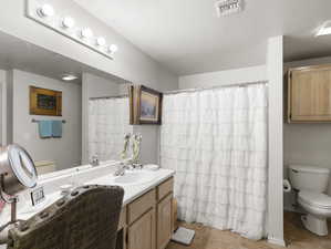 Bathroom with vanity, tile patterned flooring, and toilet