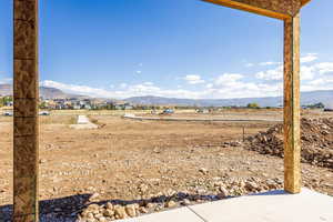 View of yard with a mountain view and a rural view