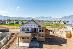 View of front of house with a mountain view and a patio area