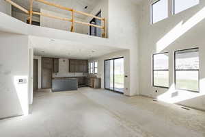 Unfurnished living room with a high ceiling