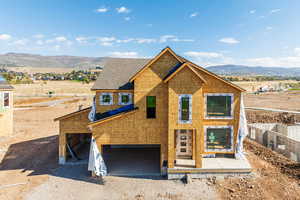 Unfinished property featuring a garage and a mountain view