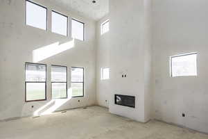 Unfurnished living room with a high ceiling