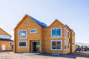 Back of property with a mountain view