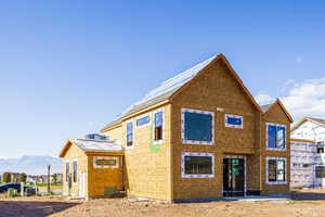 Rear view of house featuring a mountain view