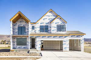 Property in mid-construction featuring a garage