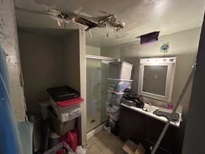 Bathroom with vanity, walk in shower, and tile patterned floors