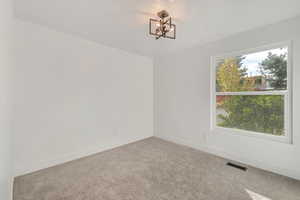 Bedroom #3. Main level. Spare room featuring light colored carpet