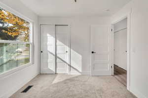 Bedroom #3. Main level. Spare room featuring light colored carpet