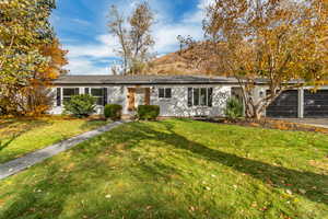 Single story home with a front lawn and a garage