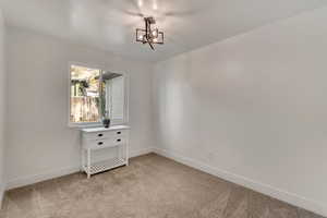 Bedroom #4. Main level. View of carpeted empty room