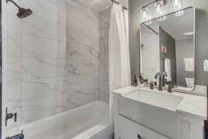 Full Bathroom on main level. Full bathroom with vanity, toilet, and shower / bathtub combination with curtain