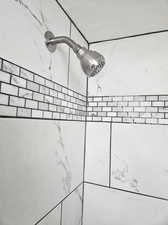 Room details featuring tiled shower