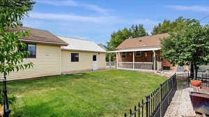 Nice backyard with fenced off vegetable garden, peach and plum tree, and small RV parking