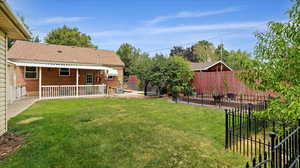 Large Back yard with vegetable garden, fruit trees and covered patio