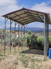 View of yard with a mountain view and a carport