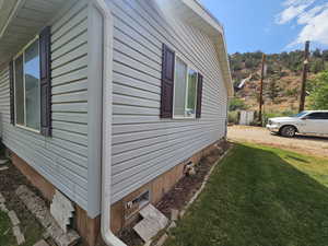 View of side of property featuring a yard