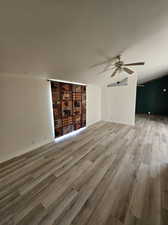 Unfurnished living room with ceiling fan and hardwood / wood-style floors