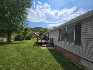 View of yard with a wooden deck