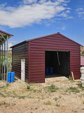 View of outdoor structure featuring a garage