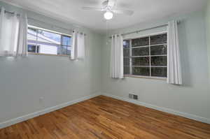 Unfurnished room with wood flooring and ceiling fan