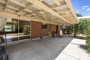 View of covered patio with large sliding glass door