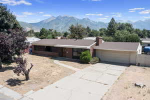 Ranch-style house featuring a garage and a mountain view