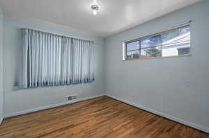 Empty room featuring hardwood floors