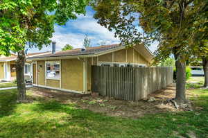 View of side of property featuring a lawn