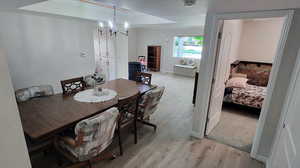 Dining area featuring an inviting chandelier and light hardwood / wood-style floors