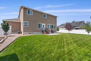 Fully fenced, fully landscaped yard for easy care with productive vegetable garden raised beds.