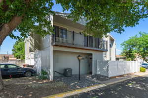 View of front of house with a balcony and central air condition unit