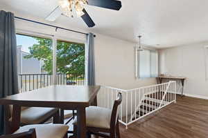 Dining room with hardwood / wood-style flooring and ceiling fan