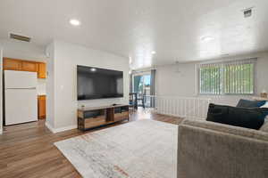 Living room with light hardwood / wood-style floors