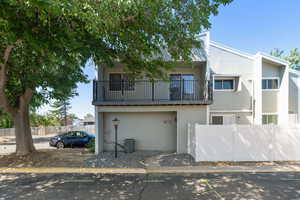 View of front of home featuring a balcony and a garage