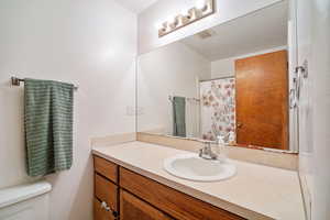 Bathroom featuring vanity and toilet