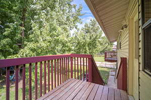 View of wooden terrace off of owner bedroom and wooden deck off dining