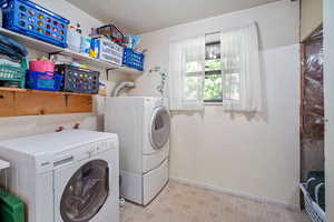 Clothes washing area with light tile patterned floors