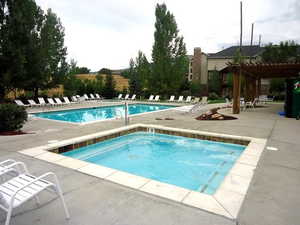 View of the hot tub area, featuring mountain views, and patio area