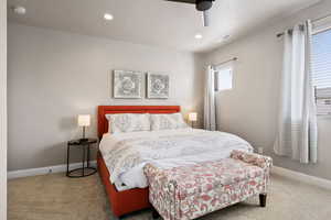 Bedroom featuring ceiling fan and carpet flooring