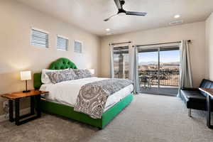 Carpeted bedroom featuring access to exterior and ceiling fan