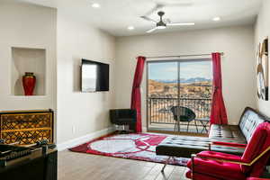 Living room featuring light hardwood / wood-style floors and ceiling fan