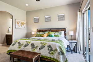 Bedroom with connected bathroom and hardwood / wood-style floors