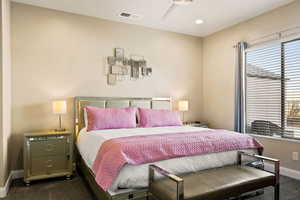 Carpeted bedroom featuring ceiling fan