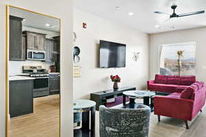 Living room featuring light wood-type flooring and ceiling fan