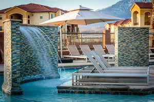 View of swimming pool with a mountain view and pool water feature