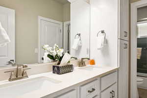 Bathroom featuring dual vanity and toilet