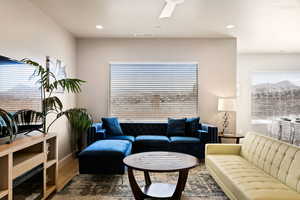 Living room featuring wood-type flooring, a wealth of natural light, and ceiling fan