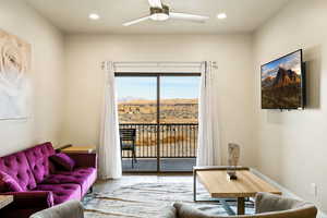 Living room featuring light hardwood / wood-style flooring and ceiling fan