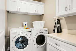 Laundry area with cabinets and washer and dryer